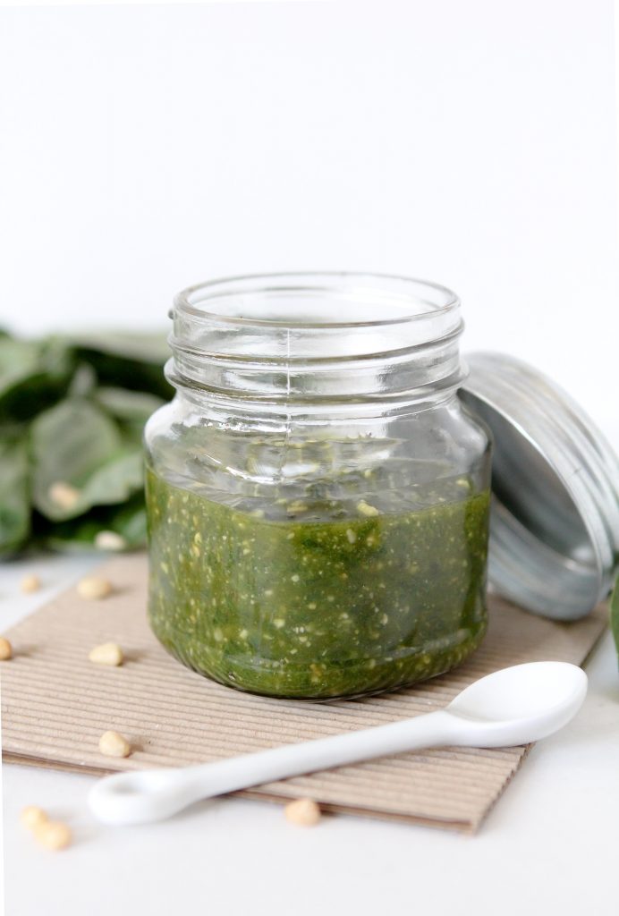 side view of a jar of homemade dairy-free paleo pesto made with pine nuts and cashews