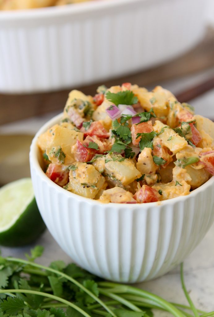 side view of a bowl of healthy potato salad with chipotle, poblanos and cilantro