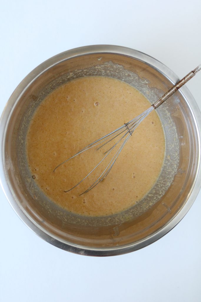 batter for pumpkin baked oatmeal recipe being whisked in a metal bowl 