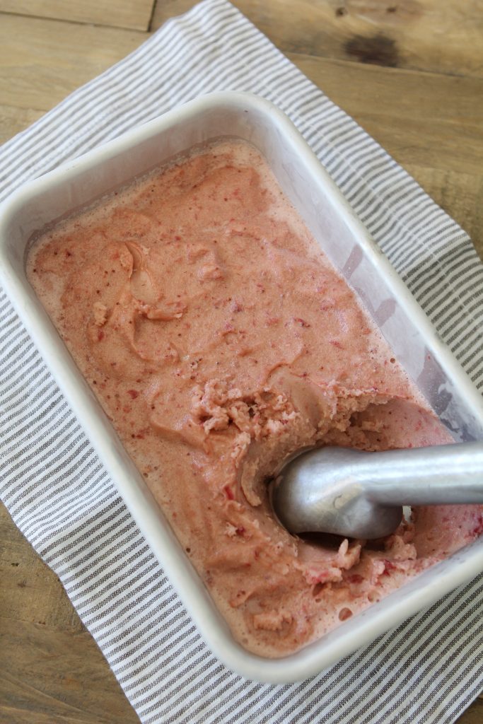 overhead shot of a loaf pan with homemade dairy-free strawberry ice cream 