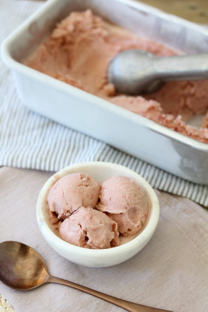 dairy-free strawberry ice cream in a small white bowl