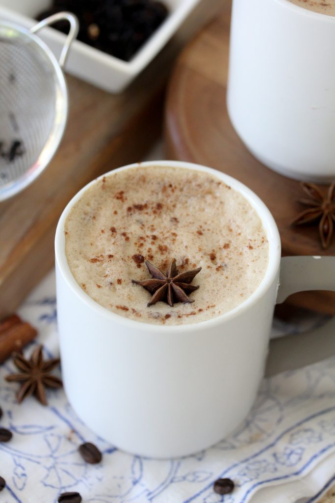 a mug of Paleo Dairy-Free Dirty Chai Latte topped with almond milk foam and dusted with cinnamon