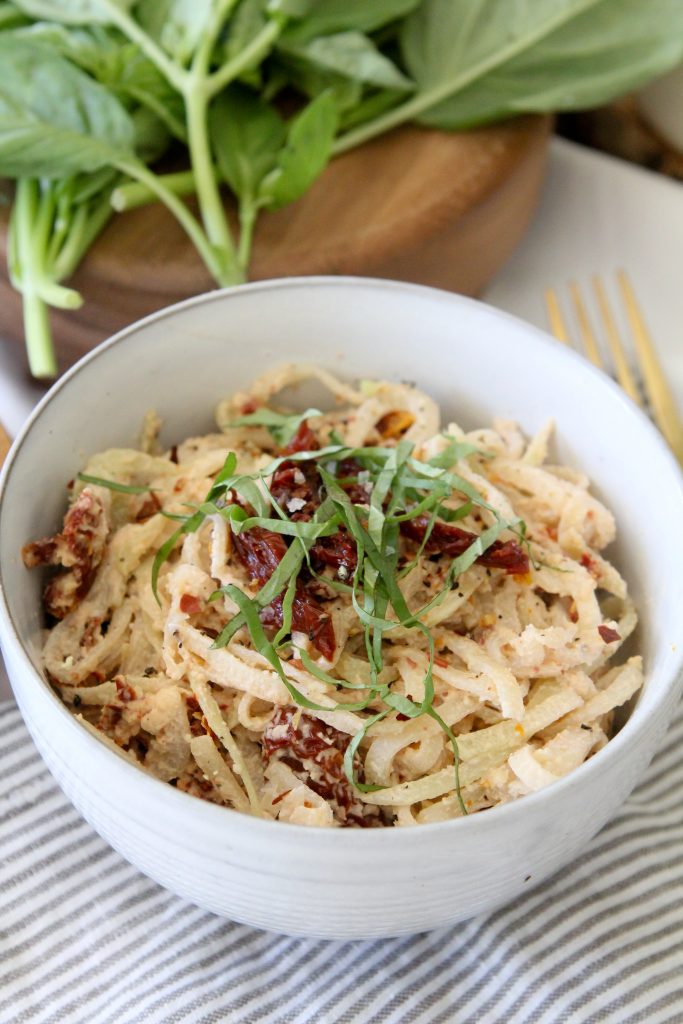 close-up of a bowl of Creamy Sun-Dried Tomato Vegetable Noodles made from kohlrabi