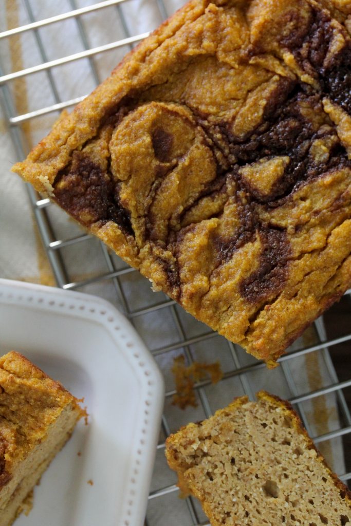 overhead shot of Grain-Free Paleo Cinnamon Swirl Pumpkin Bread on a wire cooling rack