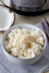 a bowl of fluffy Instant Pot coconut rice topped with shredded coconut