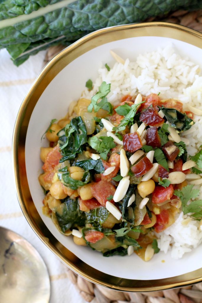 overhead shot of a bowl of vegan chickpea curry with kale served over rice 