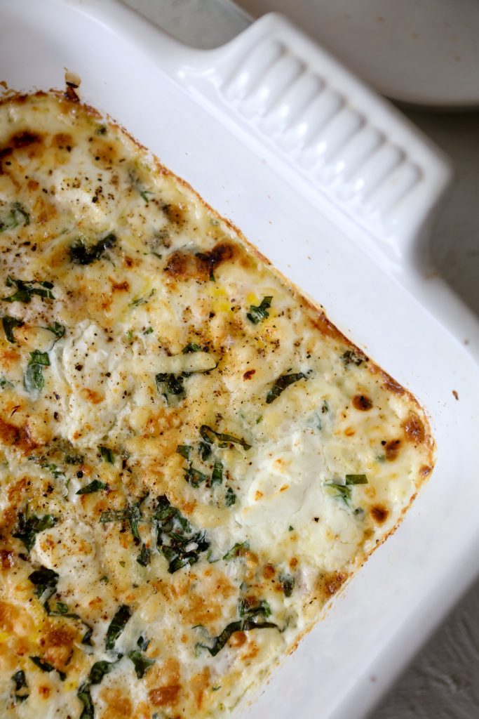 close-up of casserole with healthy baked egg breakfast casserole with tomatoes and basil