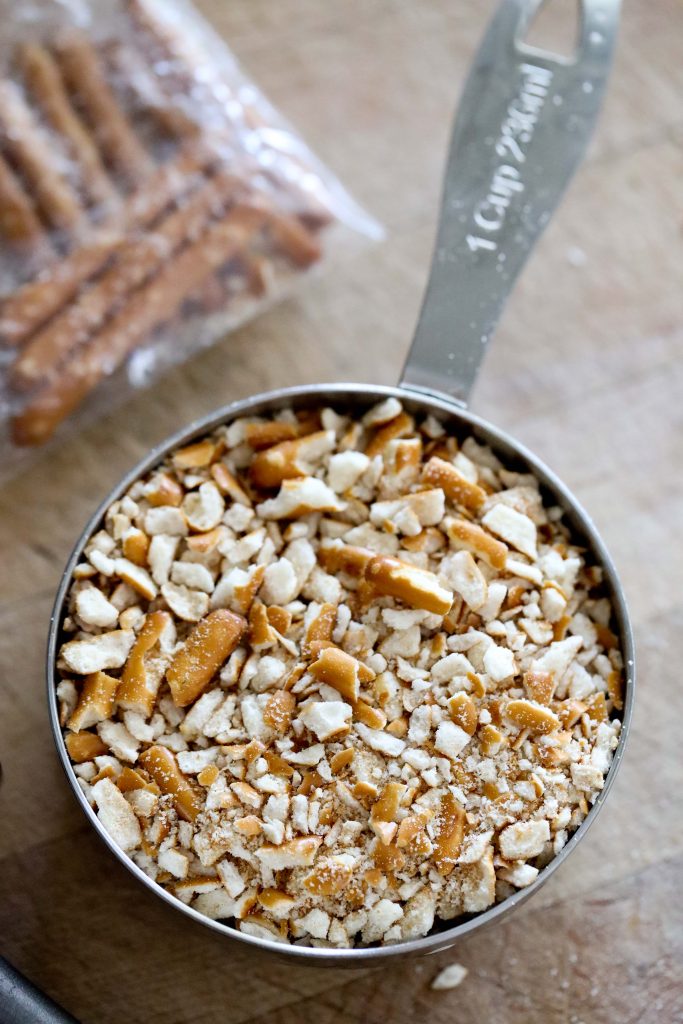 crushed gluten-free pretzels in a measuring cup 