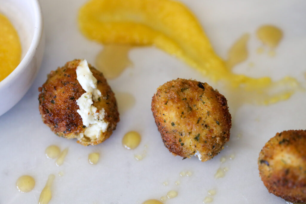 Fried ball of goat cheese with dipping sauce