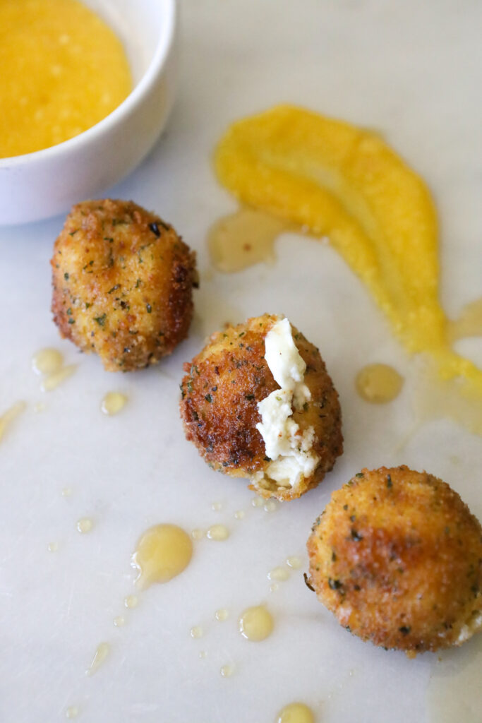 Fried ball of goat cheese with dipping sauce