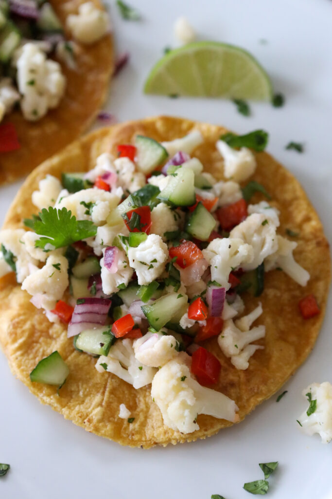 chopped cauliflower and vegetables ceviche on a crispy tortilla