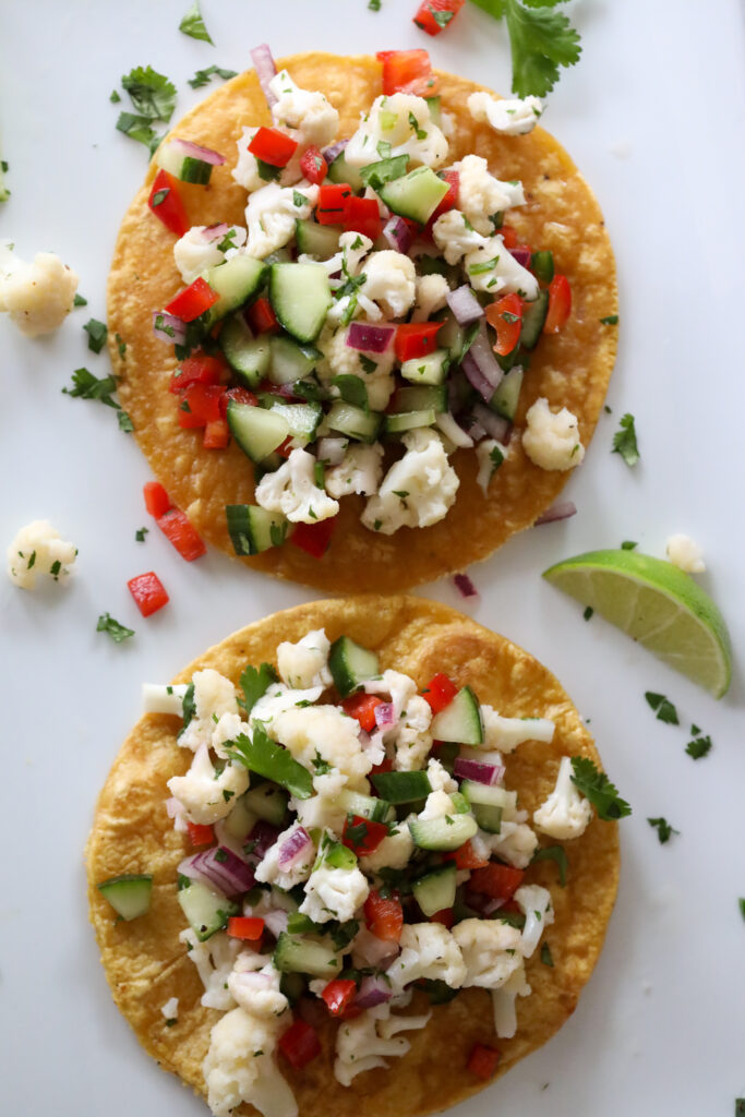 chopped cauliflower and vegetables ceviche on a crispy tortilla